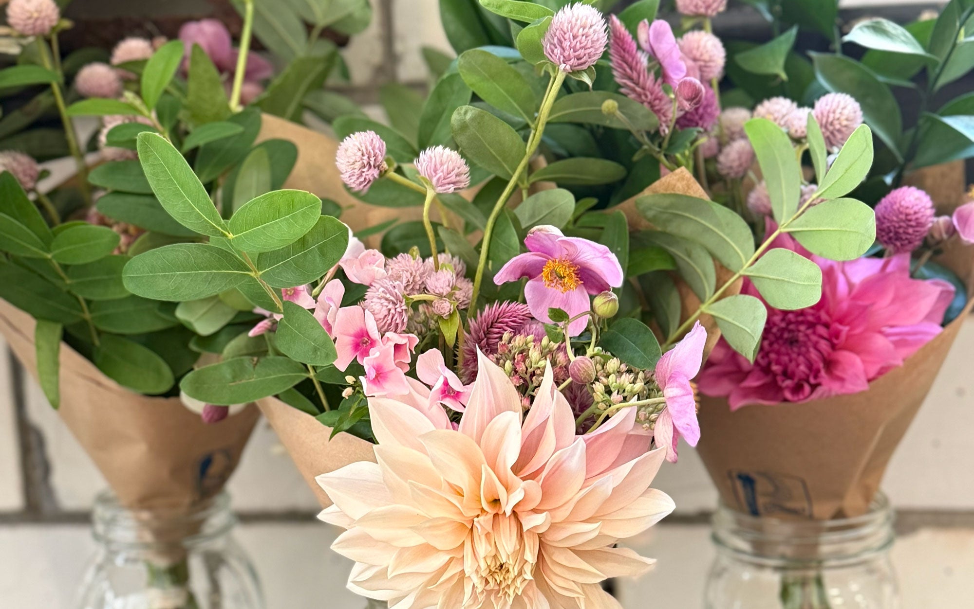 Bouquets of flowers in paper cones on a neutral background